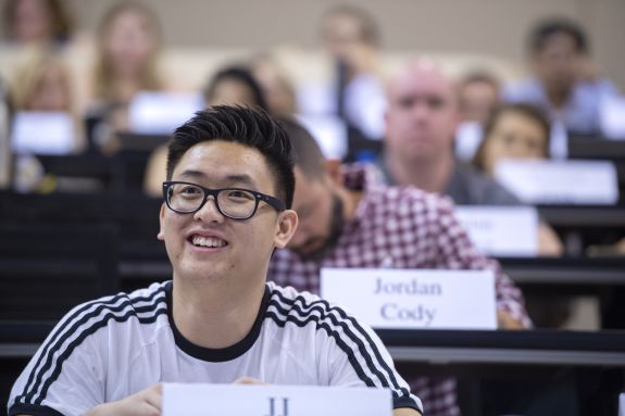 guy in glasses smiles