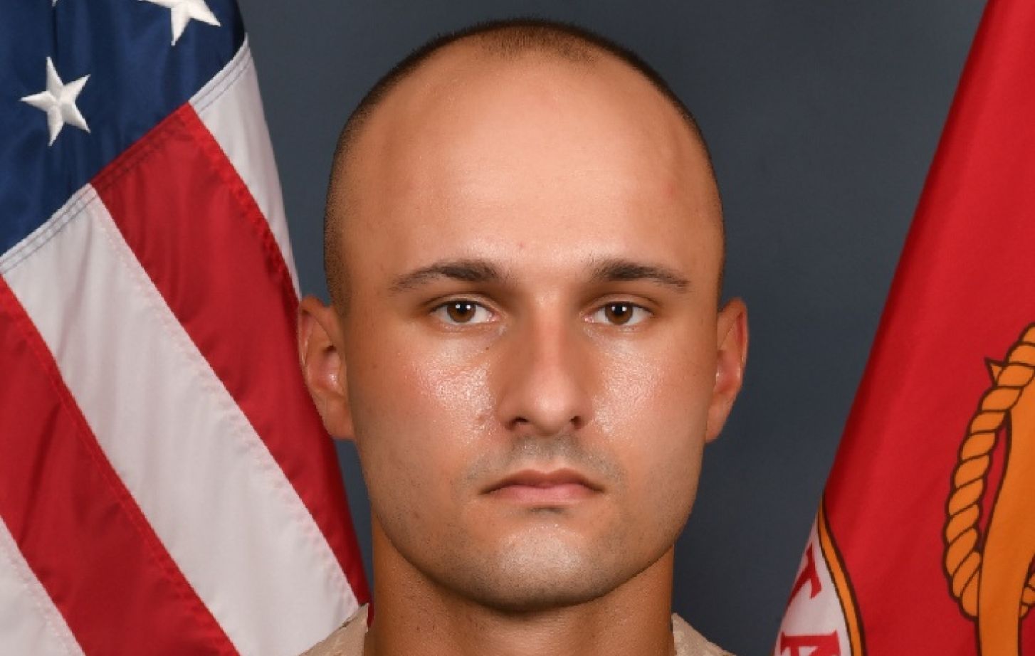 A portrait of Ian Worrell, wearing a military uniform. The background of the image is an American flag and another red flag.