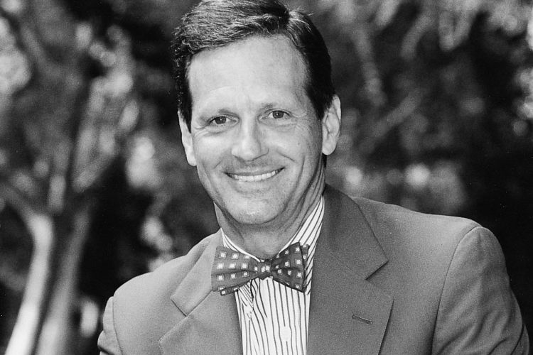 A black and white photo of a man in a suit