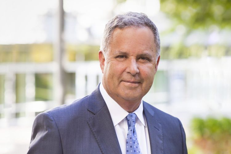 A close-up shot of a man in a suit and tie