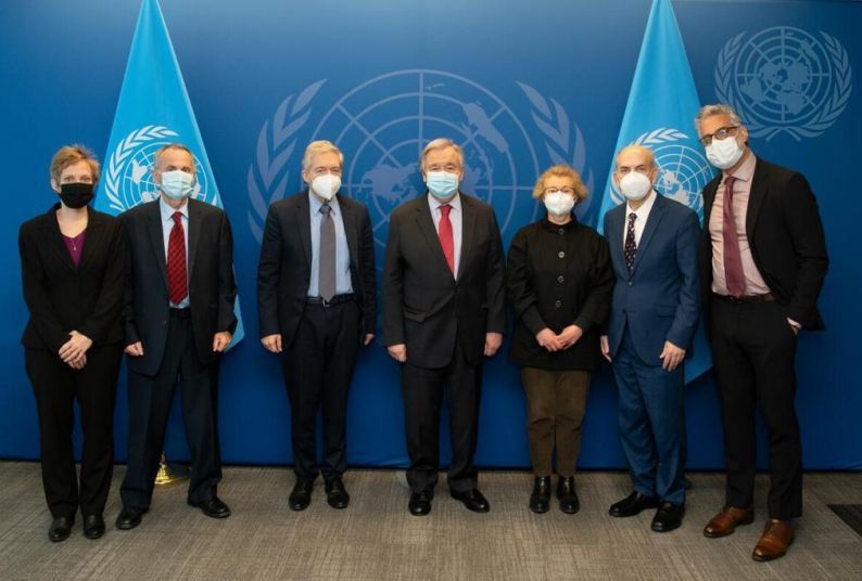 Seven people pose for a photo at the United Nations headquarters in New York 