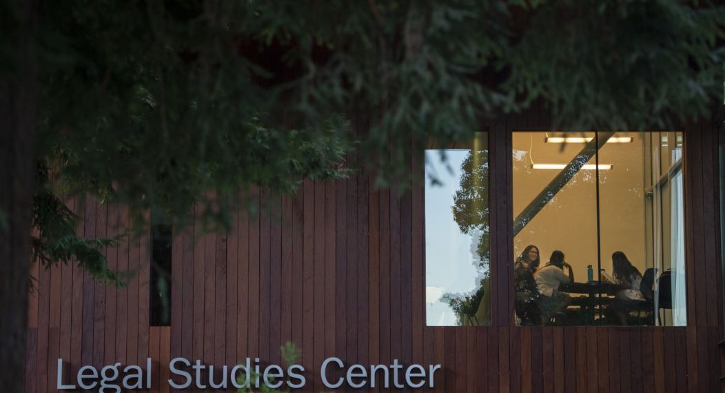 students are seen through a window studying in the Legal Studies Center
