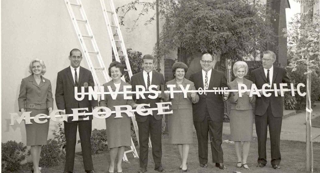 a historic photo of adults holding a 'University of the Pacific McGeorge' sign