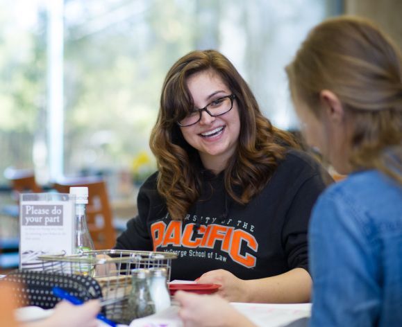 McGeoge students smiling at table