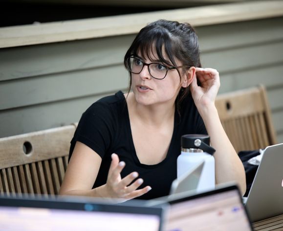 A portrait of a girl seated on a patio
