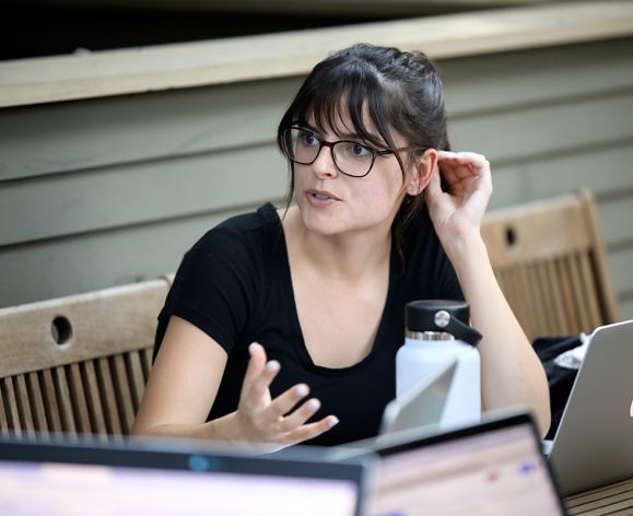 A portrait of a girl seated on a patio