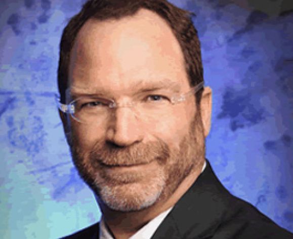 A close up portrait of a man in a suit